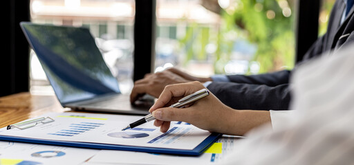 Executives and managers are meeting in a conference room, on the table there are some documents about the company's finances, managers are discussing financial information with the management.