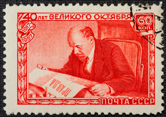 RUSSIA - circa 1957: A postage stamp printed in the USSR depicts Vladimir Lenin Ulyanov reading the...