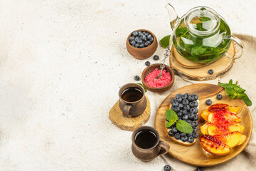 Tasty toast bread with cream cheese and ripe fruits