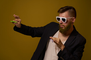 man wearing sunglasses spinner in hands fashion posing black jacket