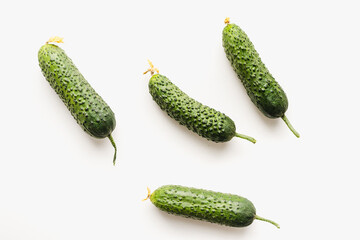 Green cucumbers on a white background. Pimpled cucumbers. 