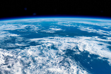 Clouds over blue sky in planet Earth. Digital Enhancement. Elements of this image furnished by NASA