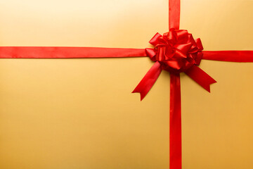 Top view of Red ribbon rolled and red bow isolated on colored background. Flat lay with copy space