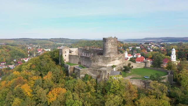 Aerial view of Bolkow Castle surrounded by yellow autumn trees, Lower Silesia, Poland
