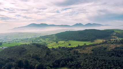 Fototapeta premium aerial view Castlewellan forest park during foggy summer morning, Northern Ireland