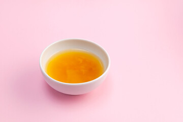 Yuja tea or yuzu tea on pink background. Selective focus, copy space. Popular Korean tea. Honey citron beverage