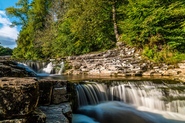 A long exposure view of the upper falls at Stainforth Force, Yorkshire in summertime