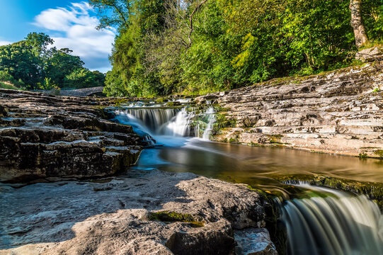 A long exposure close up view of the upper falls at Stainforth Force, Yorkshire in summertime