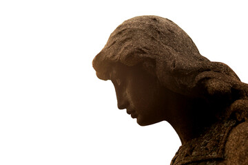 Beautiful art deco angel or Christ statue profile radiant in the morning sunlight at an old cemetery