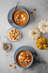Vegetarian autumn pumpkin soup with cream, seeds and toasts. Autumn and winter healthy food concept.
