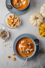 Vegetarian autumn pumpkin soup with cream, seeds and toasts. Autumn and winter healthy food concept.