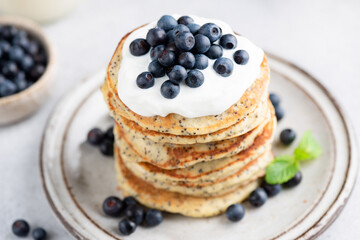 Chia seed pancakes with yogurt and blueberries on plate closeup view
