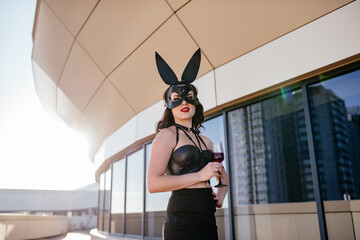 Sexy b beautiful woman posing in black bunny mask on white background. Easter bunny concept.