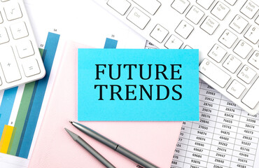 FUTURE TRENDS text on blue sticker on chart with calculator and keyboard