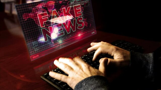 Hacker typing on the keyboard with Fake news on virtual display on desk. Broadcast, trolling, false information, hoax, propaganda, information and disinformation abstract concept.