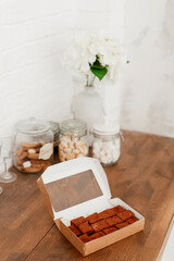 delicious bird milk in a cardboard box on a wooden table