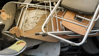 the pile of broken folding chairs. discarded folding chair in the messy disposal. the aged school...