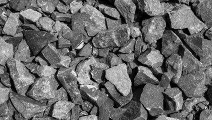 crushed gravel texture in gray. the close up look of the pile of pebbles. textured background for creative design elements.
