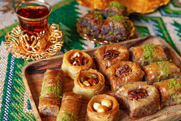 Turkish sweet baklava on metal tray with Turkish tea