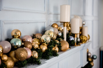 beautiful Christmas decorations over the fireplace with candles on a white background