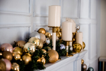 beautiful Christmas decorations over the fireplace with candles on a white background