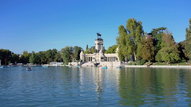 Tourists enjoying boats in Buen Retiro Park Lake, famous landmark in Madrid, Spain. High quality 4k footage