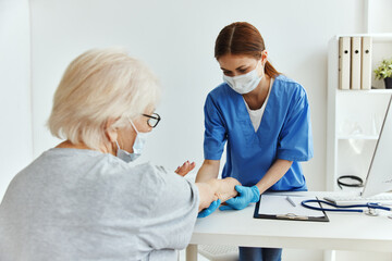 Fototapeta premium elderly woman and doctor professional examination medical office