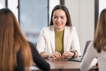 College instructors and advisors meet female college students to advise their research study. Education Concept Stock Photo