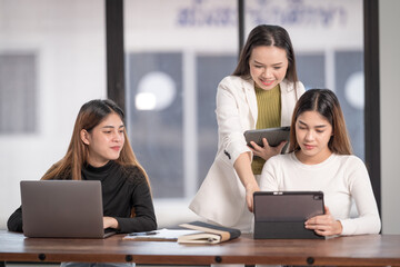 College instructors and advisors meet female college students to advise their research study. Education Concept Stock Photo