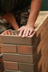 Construction. Bricklayer man worker Bricks masorny