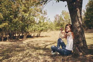 pretty woman sitting near a tree Fresh air