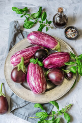 Eggplants on the plate with herbs, olive oil and spices