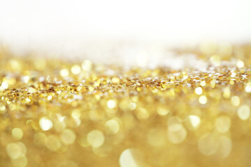 Blur soft focus Gold glitter shine dots confetti. Abstract light blink sparkle backgound.