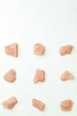 Flat lay composition with slices of raw chicken fillet on white background