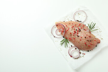 Raw chicken fillet with ingredients on white background