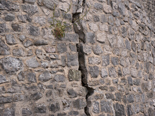 Crack in grey stone blocks of castle wall