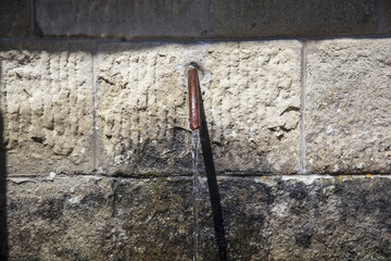 close up of an wall with a stone with fountain