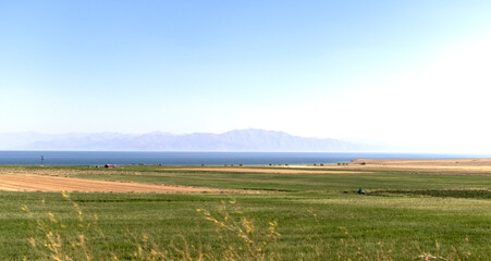 Fototapeta premium views of the sea, steppe plains and mountain silhouettes in the distance.