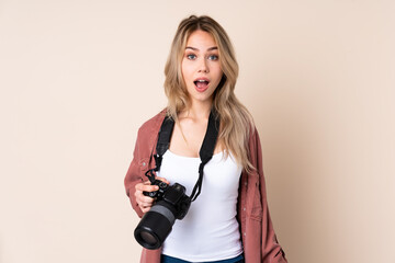 Young photographer girl over isolated background with surprise facial expression