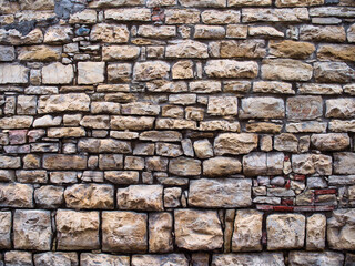 old wall of untreated stone, natural material