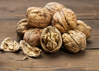 walnut on brown wooden table, close up
