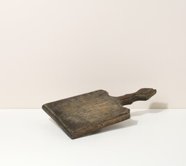 rectangular empty brown wooden kitchen board on a white table, utensils. Place to display food