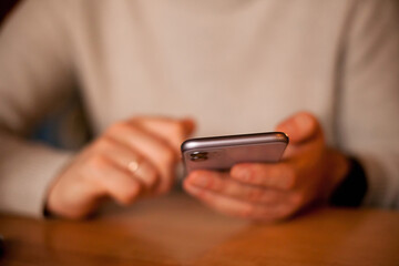 person using mobile phone for texting or social media close up