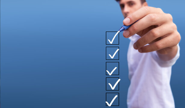 Young man checking 5 boxes with list of options on blue background