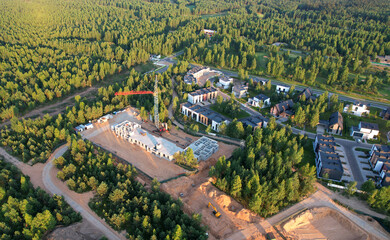 Building a country house in forest area. Unfinished private home of ceramsite concrete blocks on a construction site. Suburb houses construction. Foundation to Build a New House.