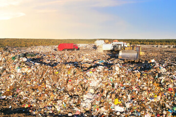Landfill waste disposal. Garbage dump with waste plastic and polyethylene. Bulldozer at landfill...