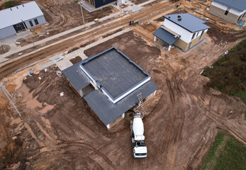 Cement mixer truck pouring mix during building a country house. Formworks and pouring concrete at...