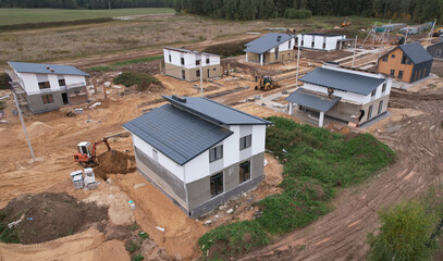 Building a country house of expanded-clay concrete blocks. Unfinished private home of ceramsite concrete blocks on a construction site.Construction work and laying bricks and roof. Suburb houses.