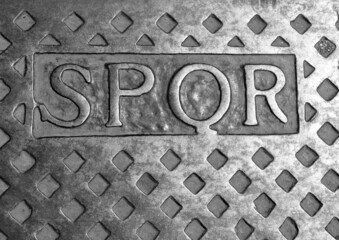 SPQR text which means Senate and People of Rome in the Latin language on a manhole cover