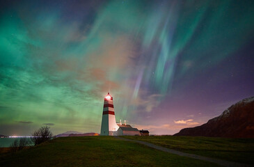 Northern lights dancing over Alnes lighthouse on Godøy, Norway